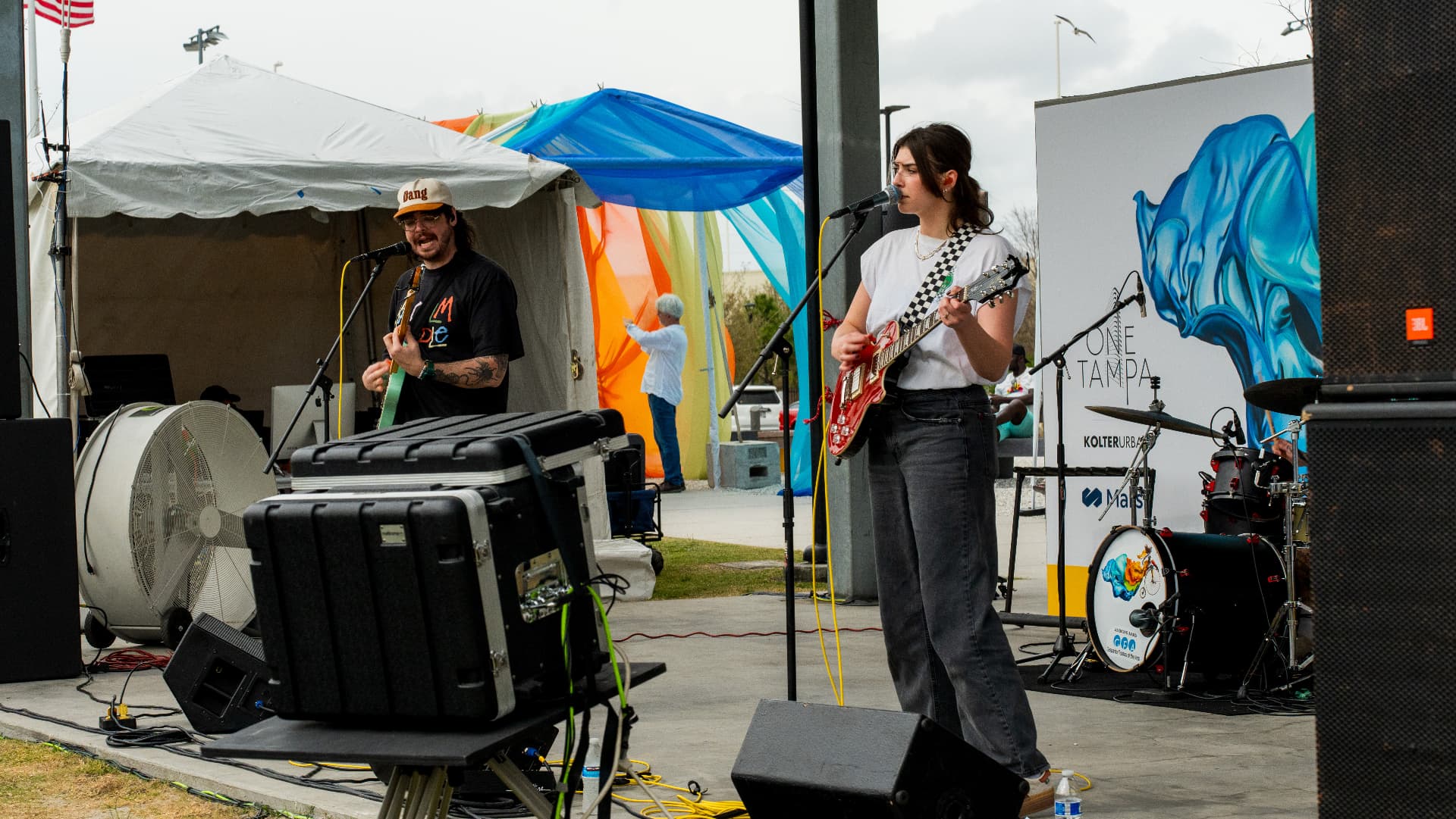 Durry's guitarists performing side by side at an outdoor festival stage