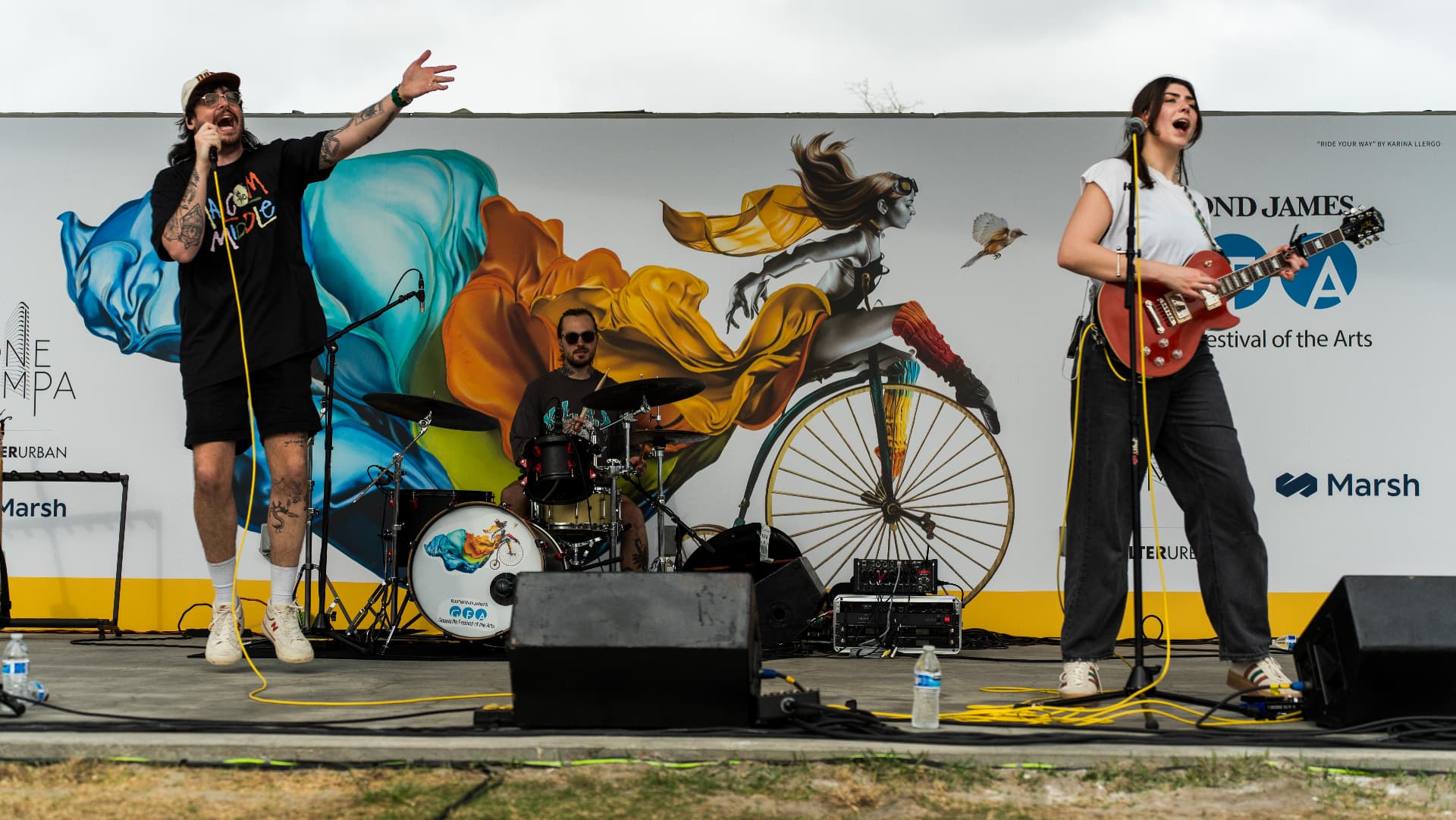 Durry performing on an outdoor stage in front of a painted mural backdrop