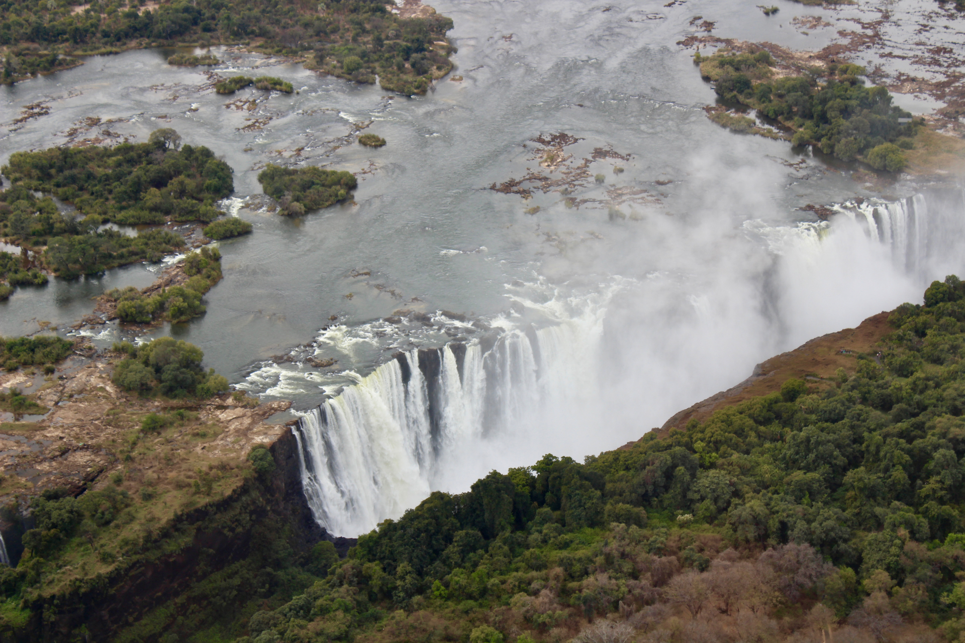 Aerial view of Victoria Falls with mist rising from the gorge